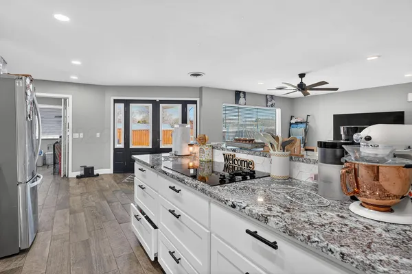 a large kitchen with sink a counter top space and stainless steel appliances