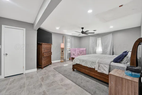 a bed room with a bed and a television