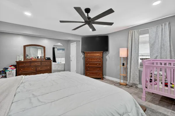 a bedroom with a bed and a chandelier