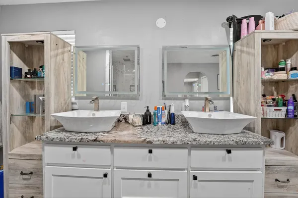 a bathroom with sink granite and mirror