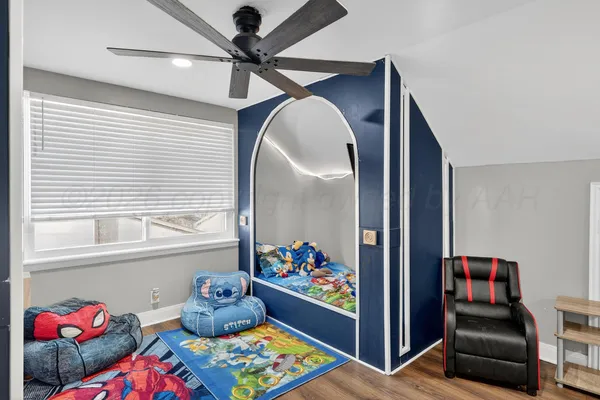 a living room with furniture and a book shelf