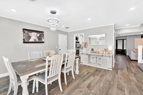 a view of a dining room with furniture and wooden floor
