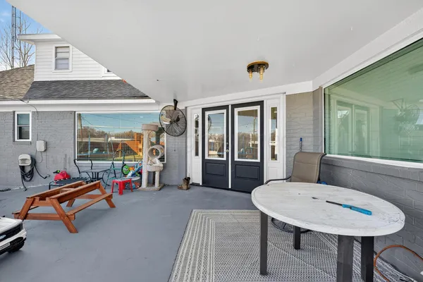 a living room with furniture a flat screen tv and a table
