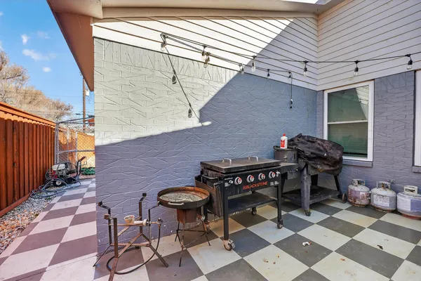 a backyard of a house with table and chairs