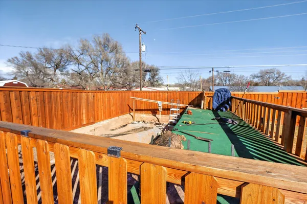a view of a balcony with wooden floor and outdoor seating