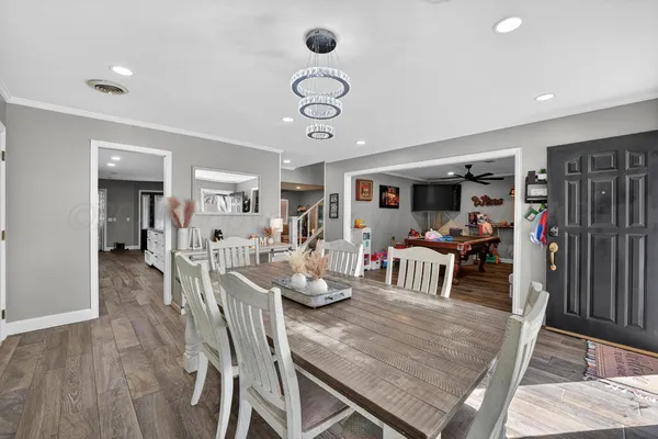 a view of a dining room with furniture and a chandelier