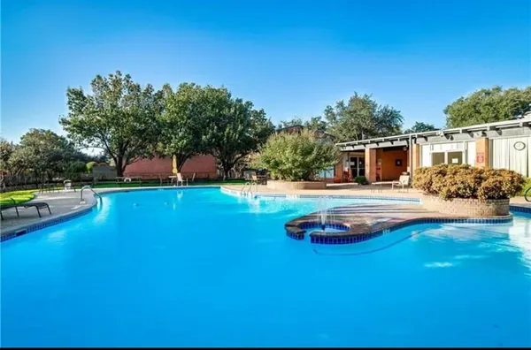 a swimming pool with outdoor seating and yard