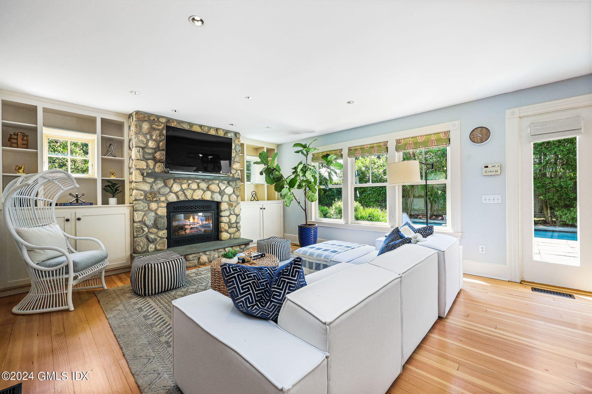 8 Hendrie Avenue Riverside, CT 06878 - Photo 16 of 33 a living room with furniture a fireplace and a flat screen tv