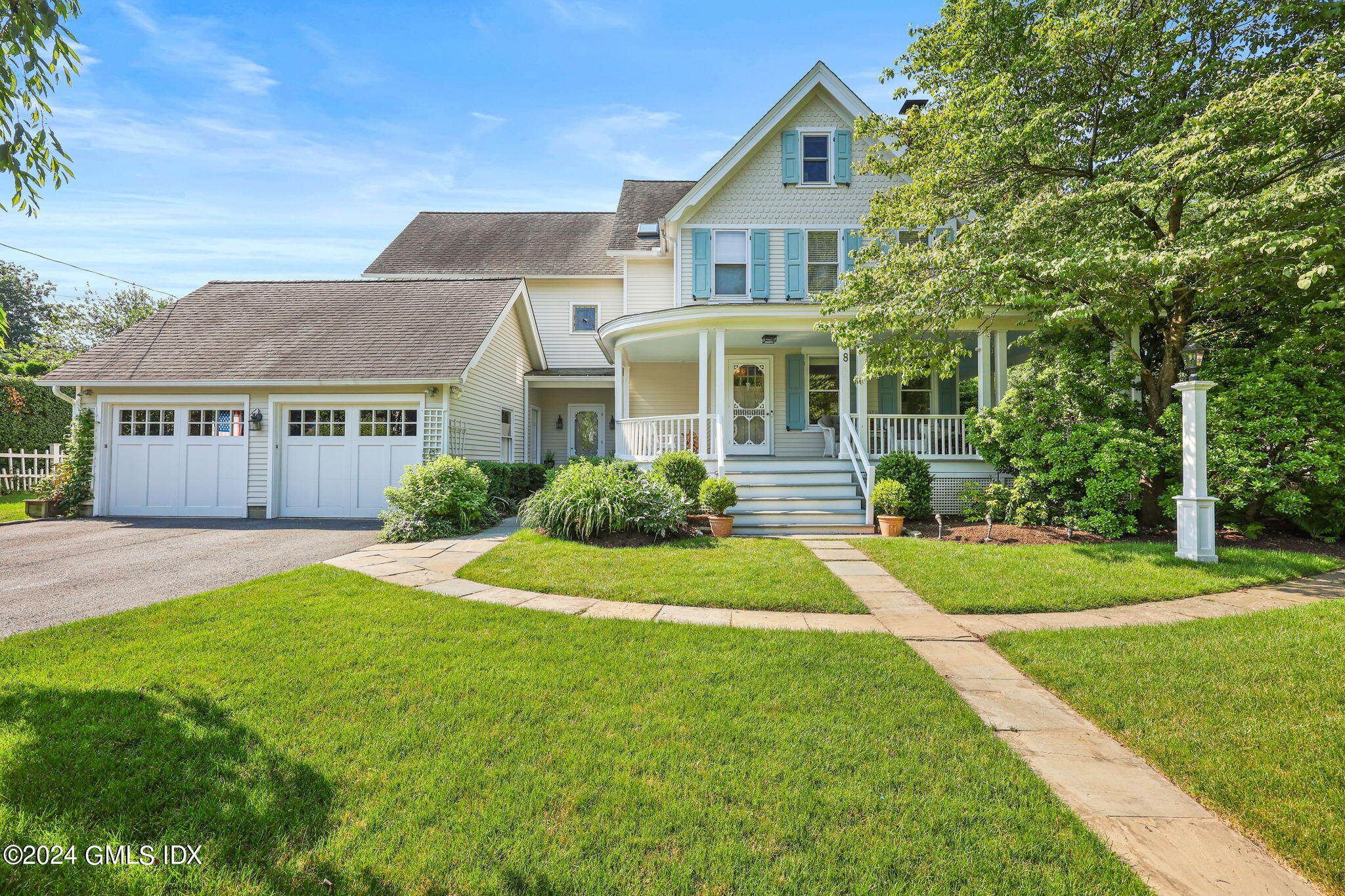 8 Hendrie Avenue Riverside, CT 06878 - Photo 2 of 33 a front view of a house with a yard and garage