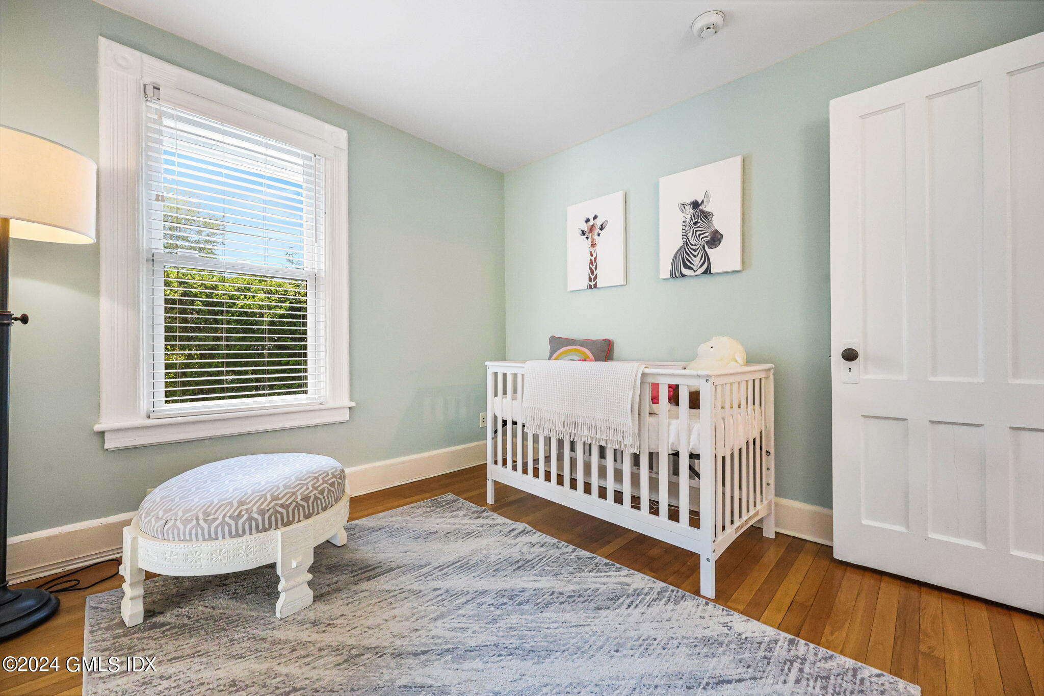 8 Hendrie Avenue Riverside, CT 06878 - Photo 23 of 33 a bedroom with a bed and wooden floor