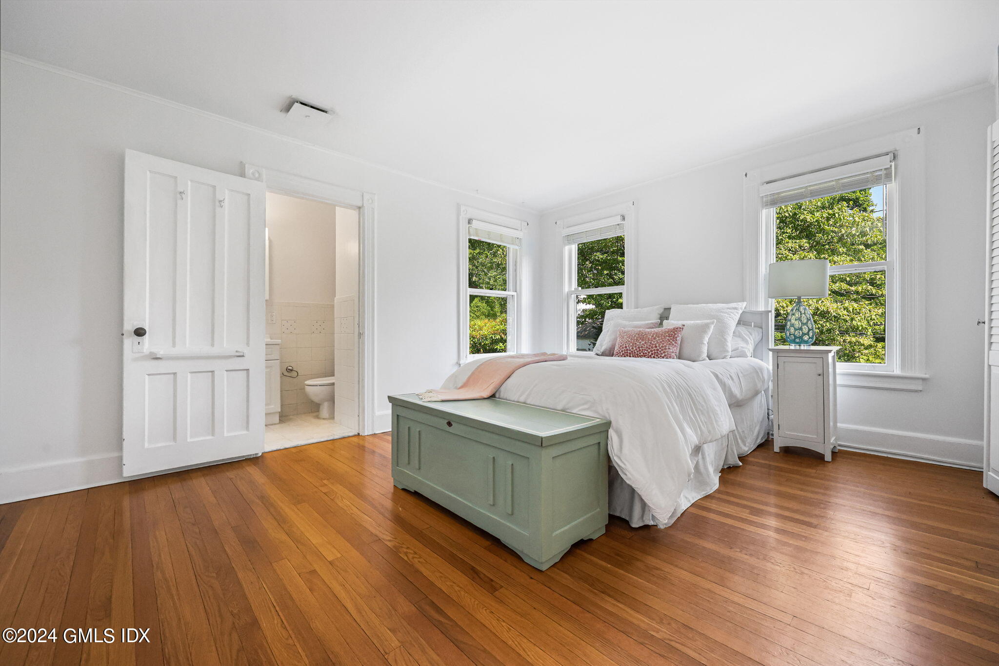 8 Hendrie Avenue Riverside, CT 06878 - Photo 24 of 33 a bedroom with a large bed wooden floor and window