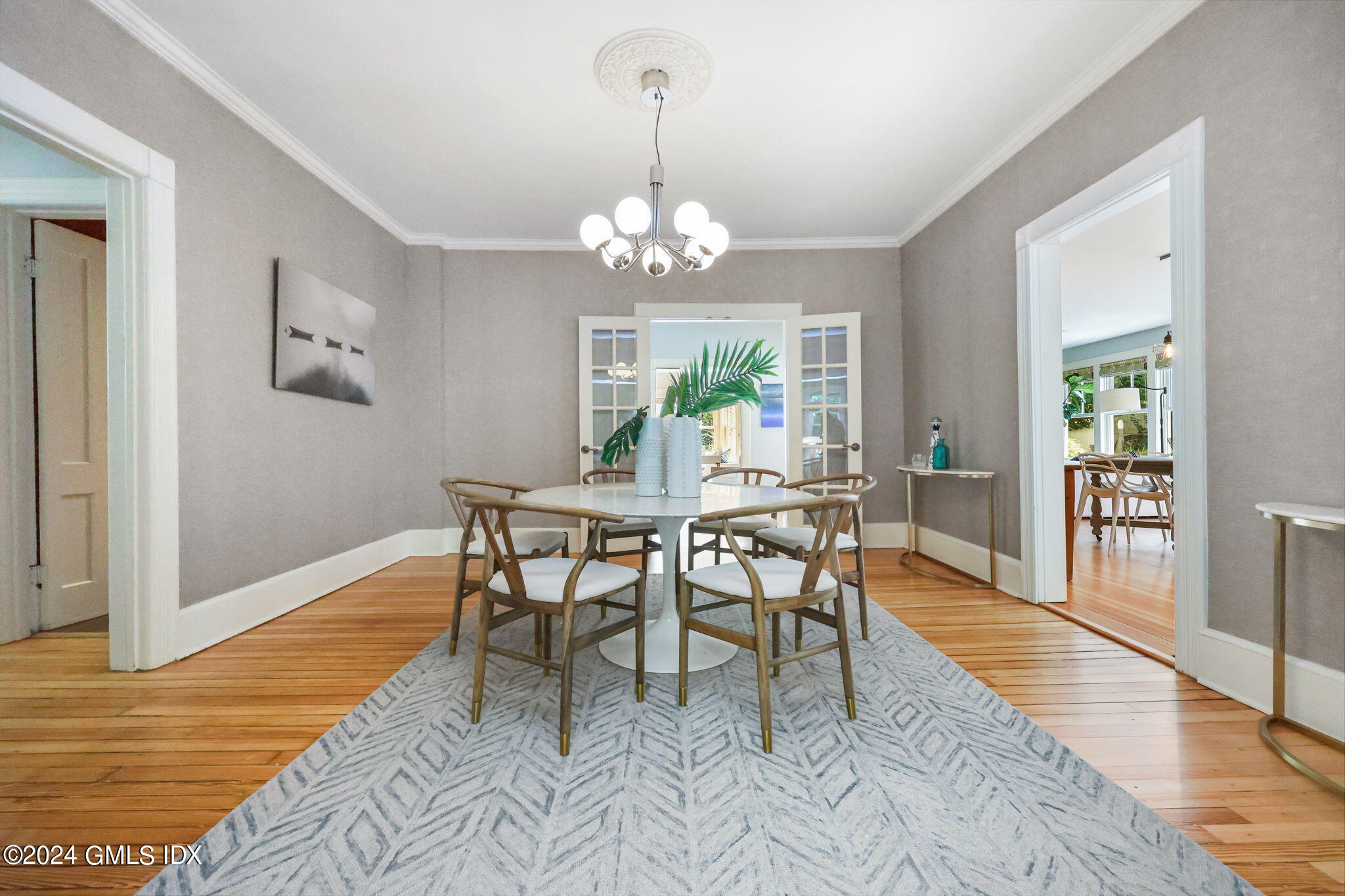 8 Hendrie Avenue Riverside, CT 06878 - Photo 10 of 33 a view of a dining room with furniture a chandelier and wooden floor