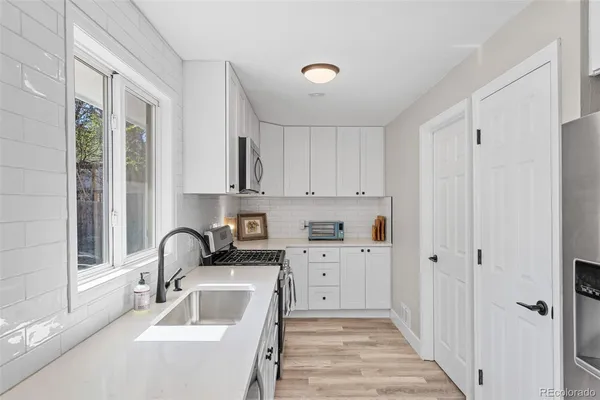 a kitchen with a sink cabinets and a window