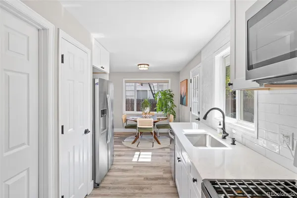 a very nice looking room with a large window and wooden floor