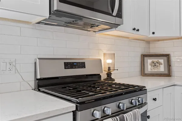 a stove top oven sitting inside of a kitchen
