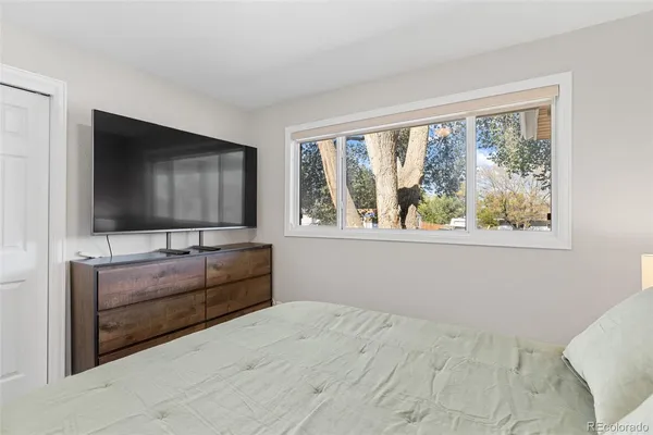 a bedroom with a bed and a flat screen tv