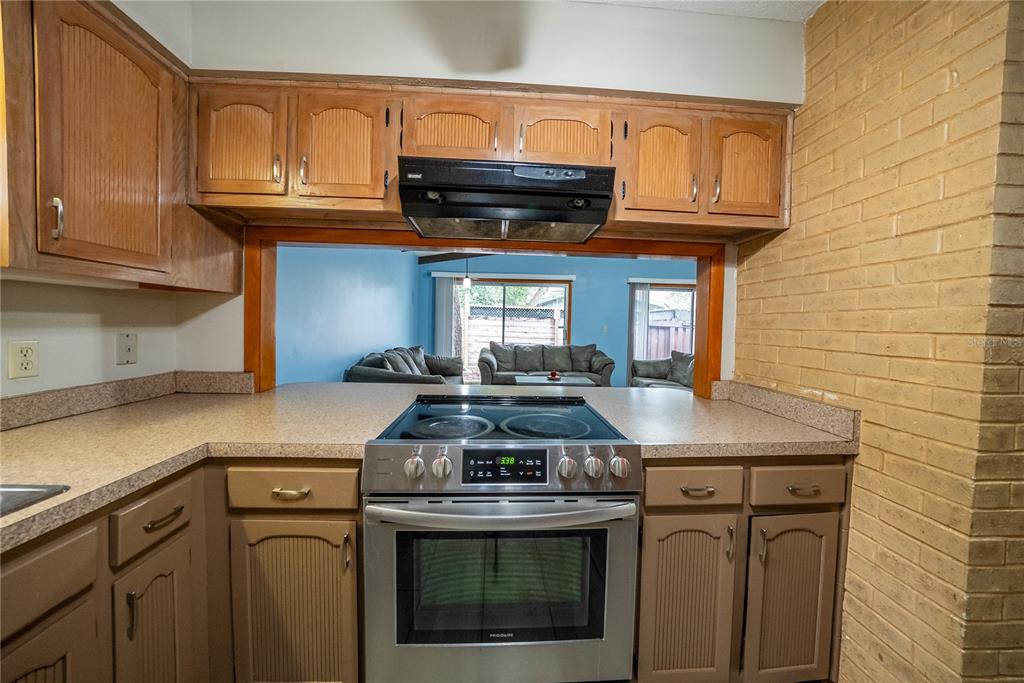 12 Spring Lake Way Ocala, FL 34472 - Photo 12 of 57 a kitchen with stainless steel appliances granite countertop a stove a sink and a microwave