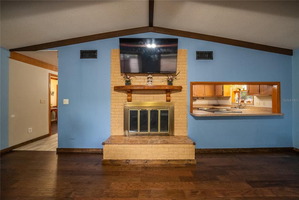 12 Spring Lake Way Ocala, FL 34472 - Photo 19 of 57 a living room with fireplace and flat screen tv