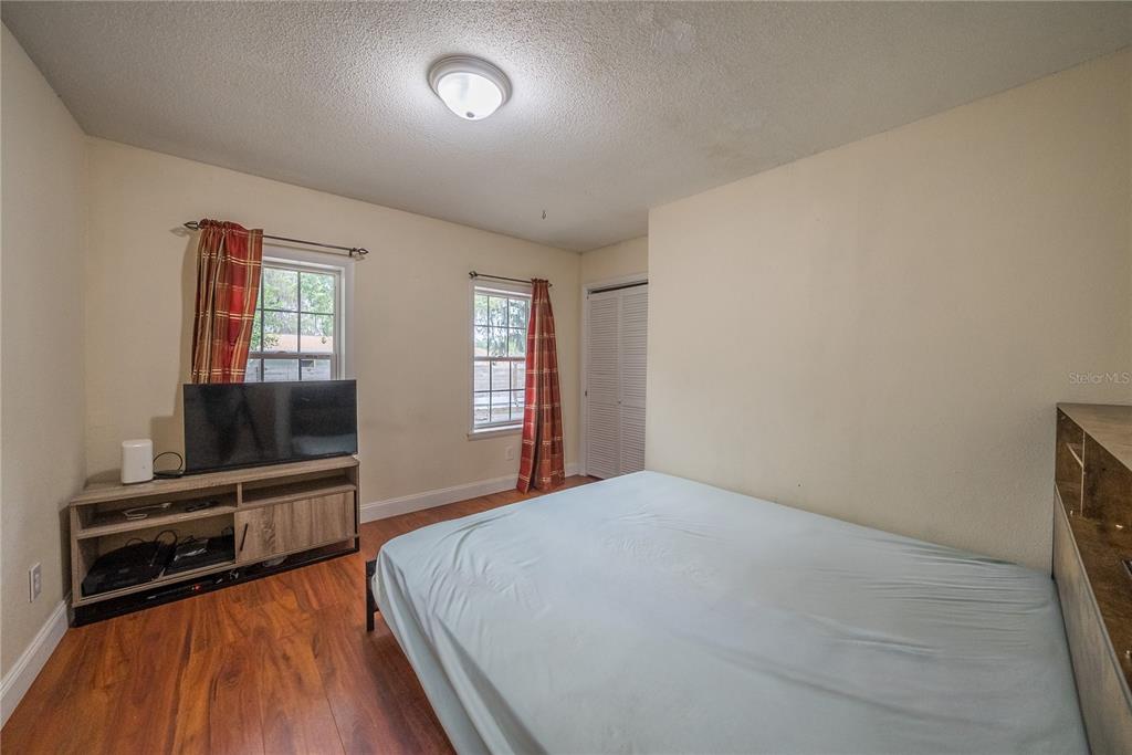 12 Spring Lake Way Ocala, FL 34472 - Photo 23 of 57 a bedroom with a bed and a television