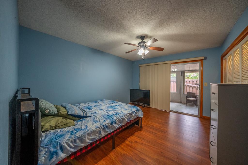 12 Spring Lake Way Ocala, FL 34472 - Photo 28 of 57 a bedroom with a bed and a chandelier