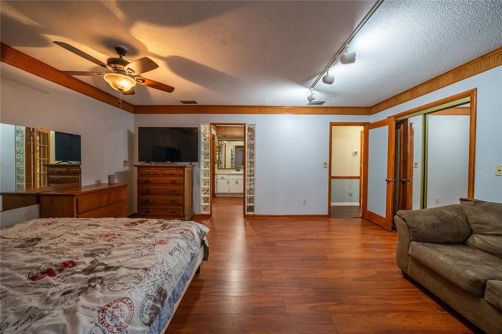12 Spring Lake Way Ocala, FL 34472 - Photo 33 of 57 a living room with furniture a chandelier and a flat screen tv