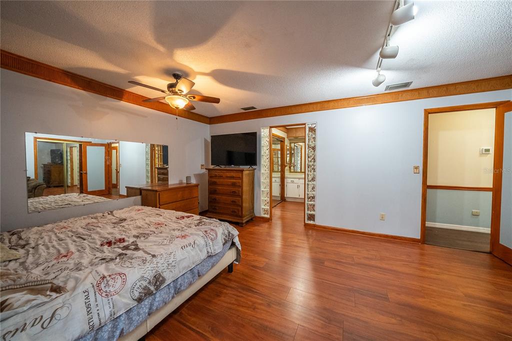 12 Spring Lake Way Ocala, FL 34472 - Photo 36 of 57 a spacious bedroom with a bed and dresser with wooden floor