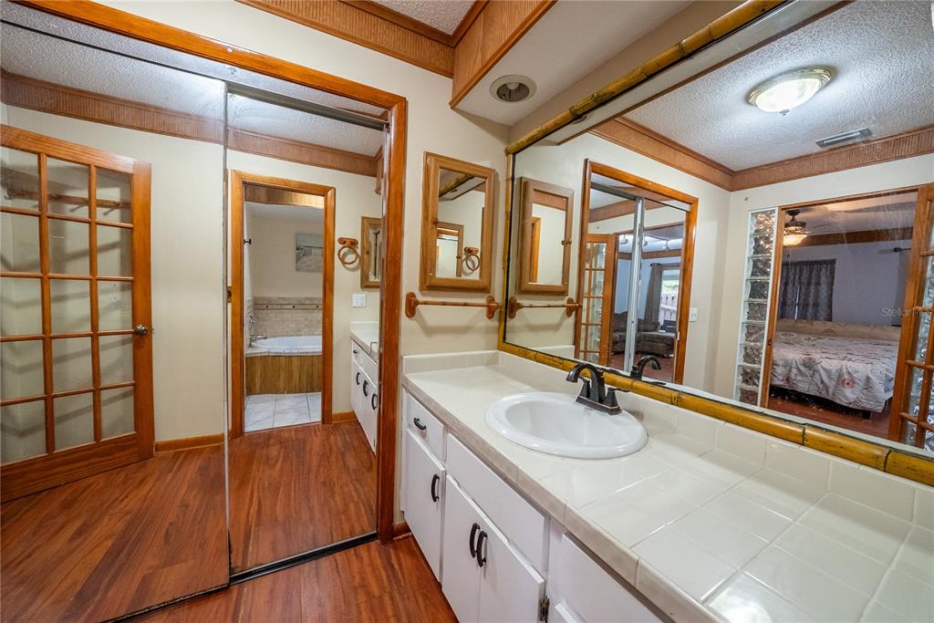 12 Spring Lake Way Ocala, FL 34472 - Photo 38 of 57 a bathroom with a granite countertop sink a mirror and shower