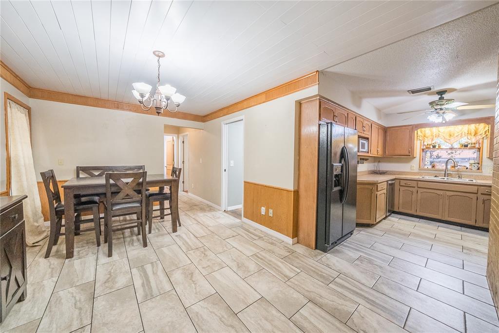 12 Spring Lake Way Ocala, FL 34472 - Photo 9 of 57 a kitchen with stainless steel appliances kitchen island granite countertop a table chairs and a refrigerator