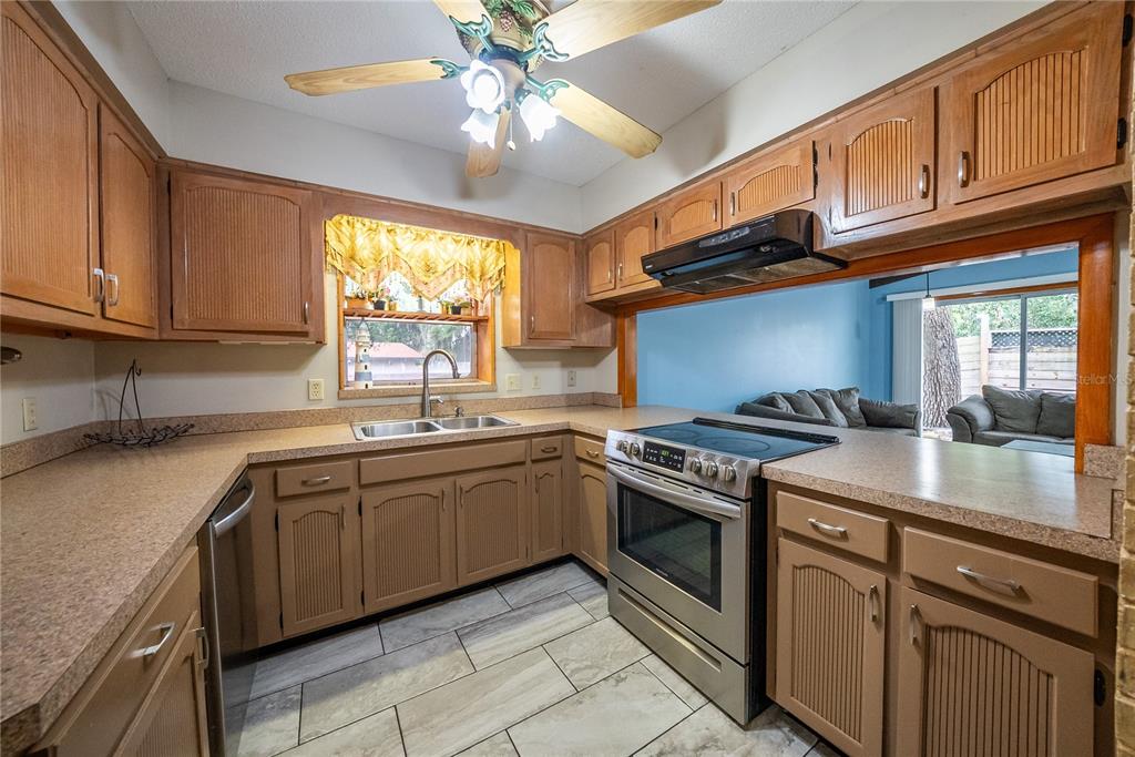 12 Spring Lake Way Ocala, FL 34472 - Photo 10 of 57 a kitchen with stainless steel appliances granite countertop a stove sink and cabinets