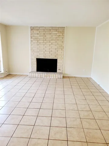 a view of an empty room with a fireplace