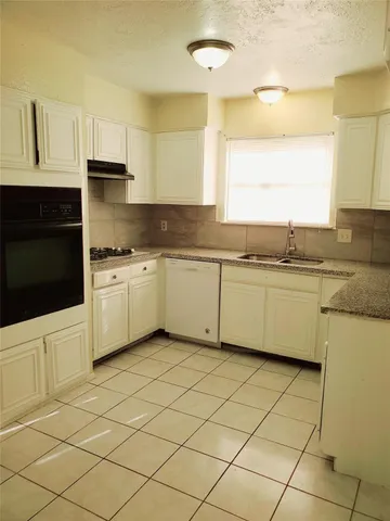 a kitchen with stainless steel appliances cabinets a sink and a stove