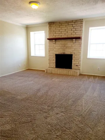 a view of empty room with a fireplace