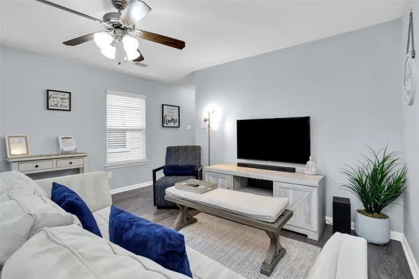 a kitchen with stainless steel appliances kitchen island granite countertop a stove a sink and a refrigerator with wooden floor