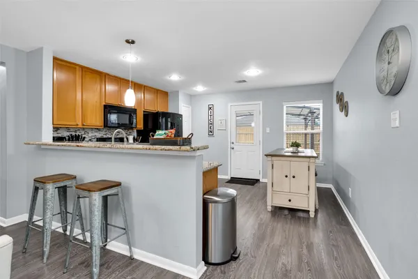a kitchen with stainless steel appliances granite countertop a refrigerator stove and sink