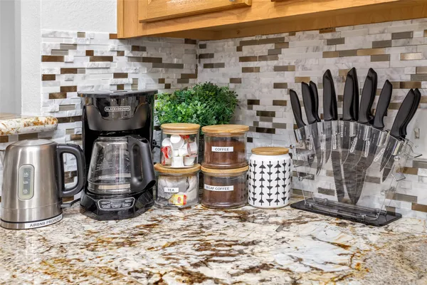 a kitchen with stainless steel appliances granite countertop a refrigerator and a stove