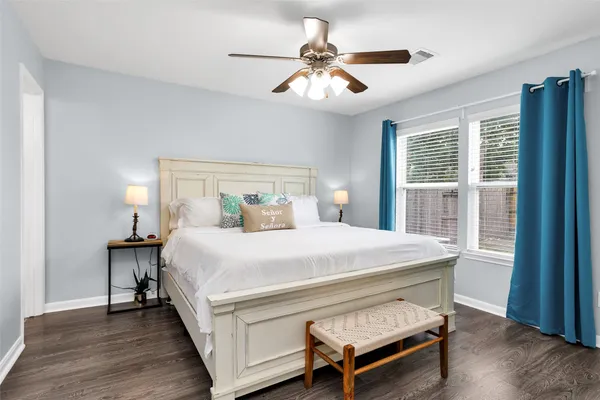 a bedroom with a large bed and a chandelier