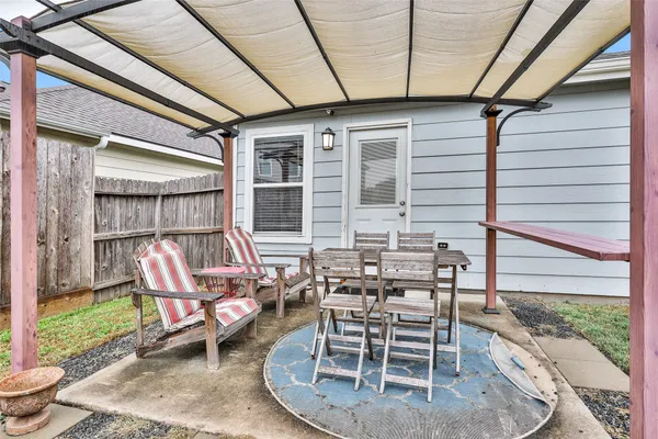 a front view of a house with patio and a yard