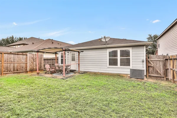 a big house with a yard and wooden fence