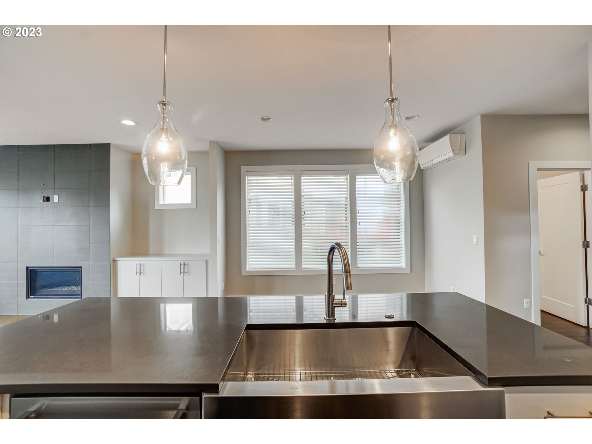 548 Southwest Chinook Terrace Portland, OR 97225 - Photo 16 of 44 a view of a kitchen with kitchen island a counter top a stove and a chandelier