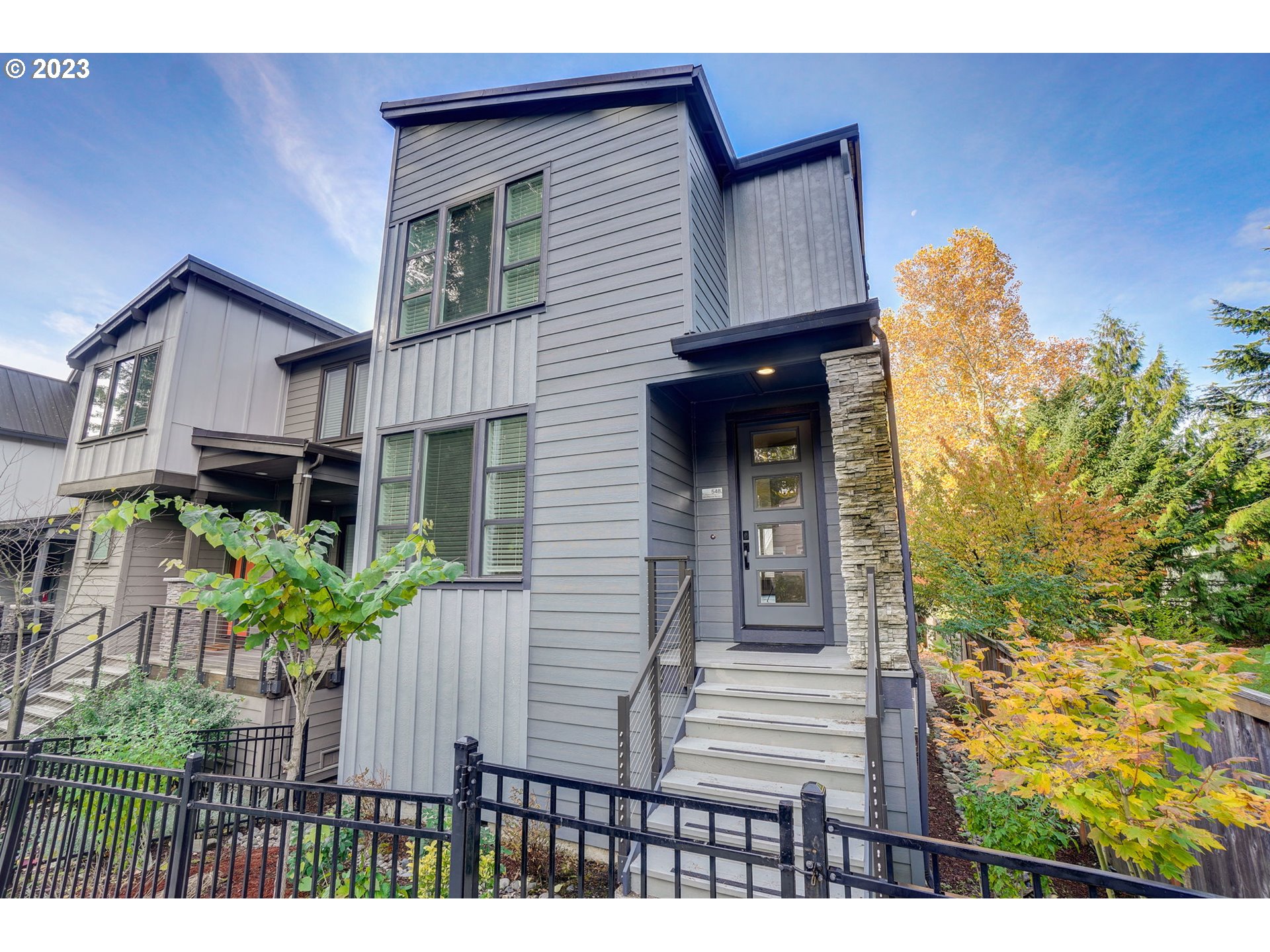548 Southwest Chinook Terrace Portland, OR 97225 - Photo 2 of 44 a view of a house with potted plants and a bench