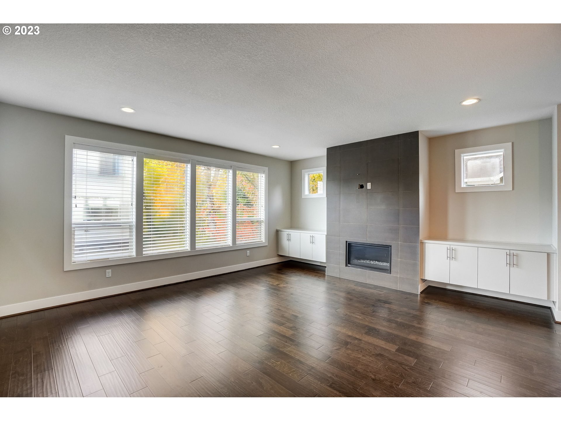 548 Southwest Chinook Terrace Portland, OR 97225 - Photo 5 of 44 a view of empty room with wooden floor and fireplace