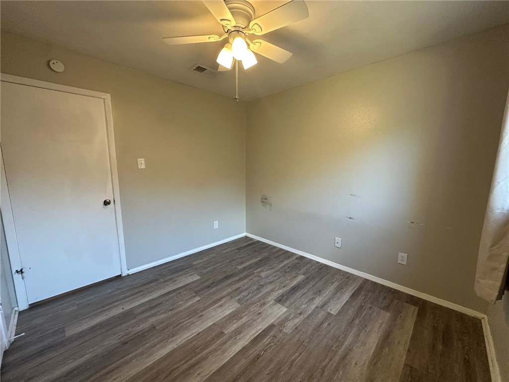 2994 Lovers Lane Ingleside, TX 78362 - Photo 23 of 39 en empty room with wooden floor and fan
