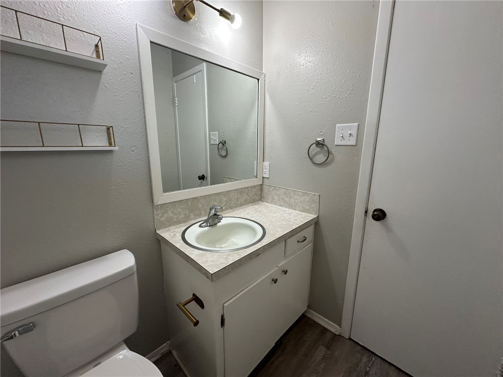 2994 Lovers Lane Ingleside, TX 78362 - Photo 38 of 39 a bathroom with a toilet sink and mirror