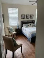 a bed sitting in a bedroom next to a window