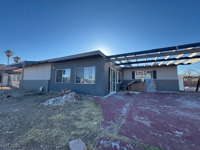 1275 Westwind Road Las Vegas, NV 89146 - Photo 3 of 30 View of front of house with brick siding and a pergola