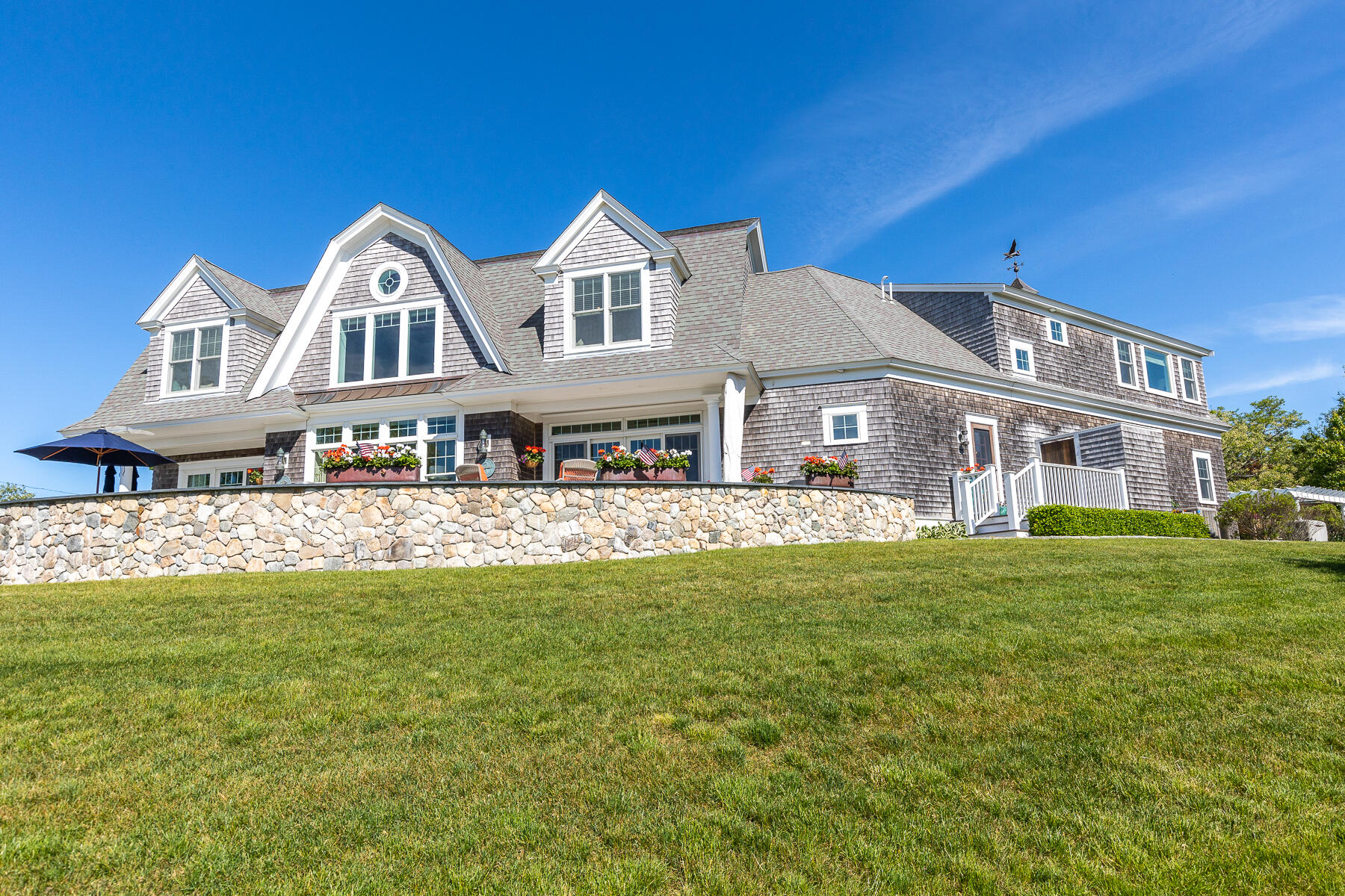 345 Robbins Hill Road Brewster, MA 02631 - Photo 17 of 95 a front view of a house with a garden