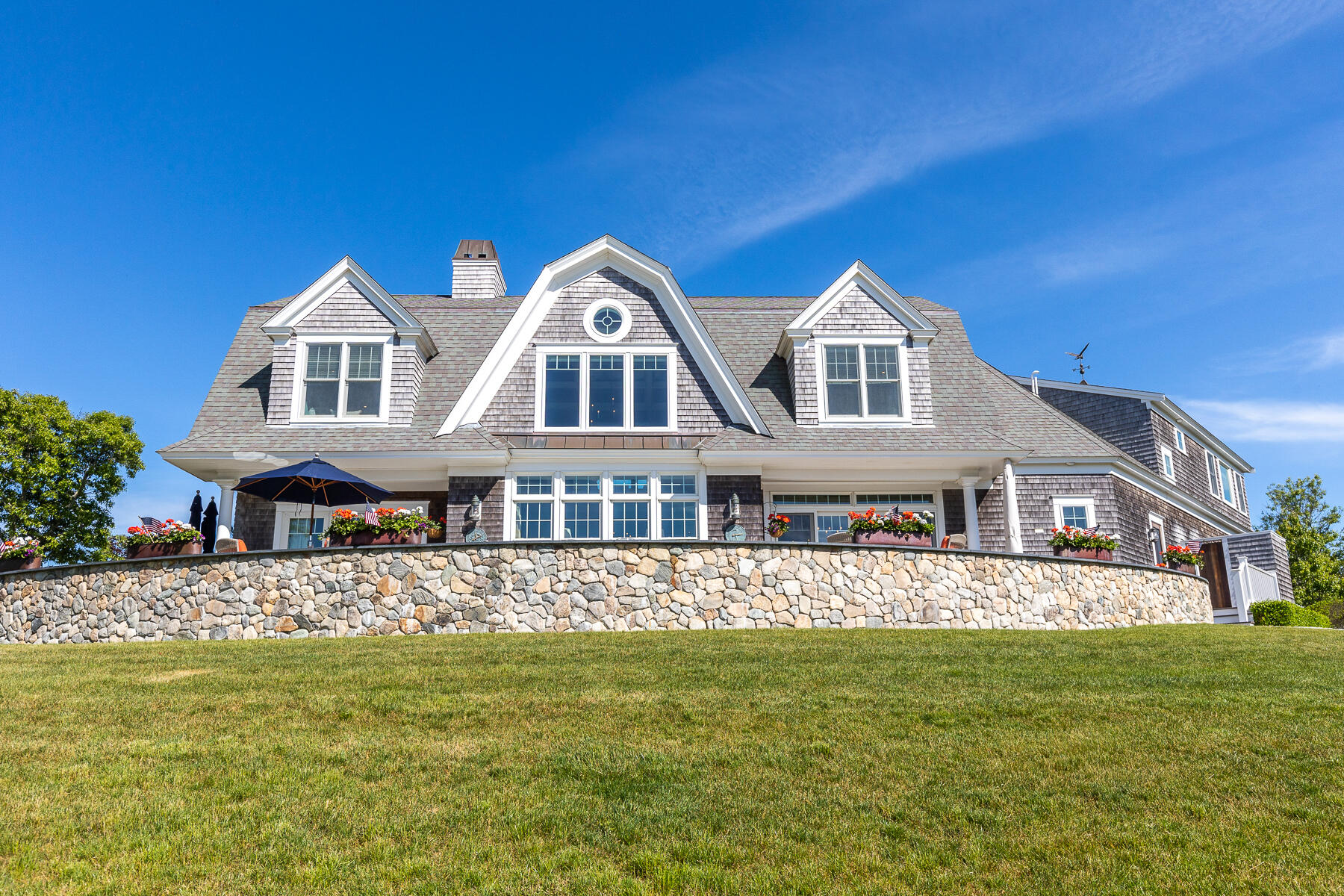 345 Robbins Hill Road Brewster, MA 02631 - Photo 24 of 95 a front view of a house with a garden