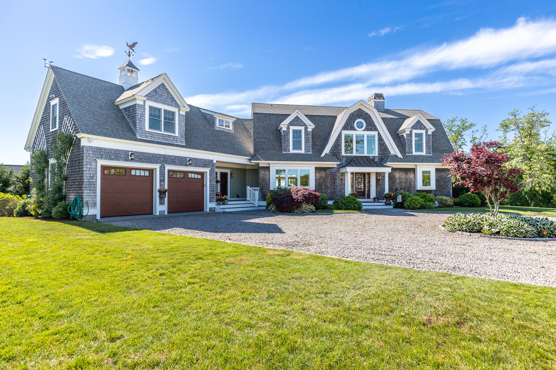 345 Robbins Hill Road Brewster, MA 02631 - Photo 27 of 95 a front view of a house with a yard and garage