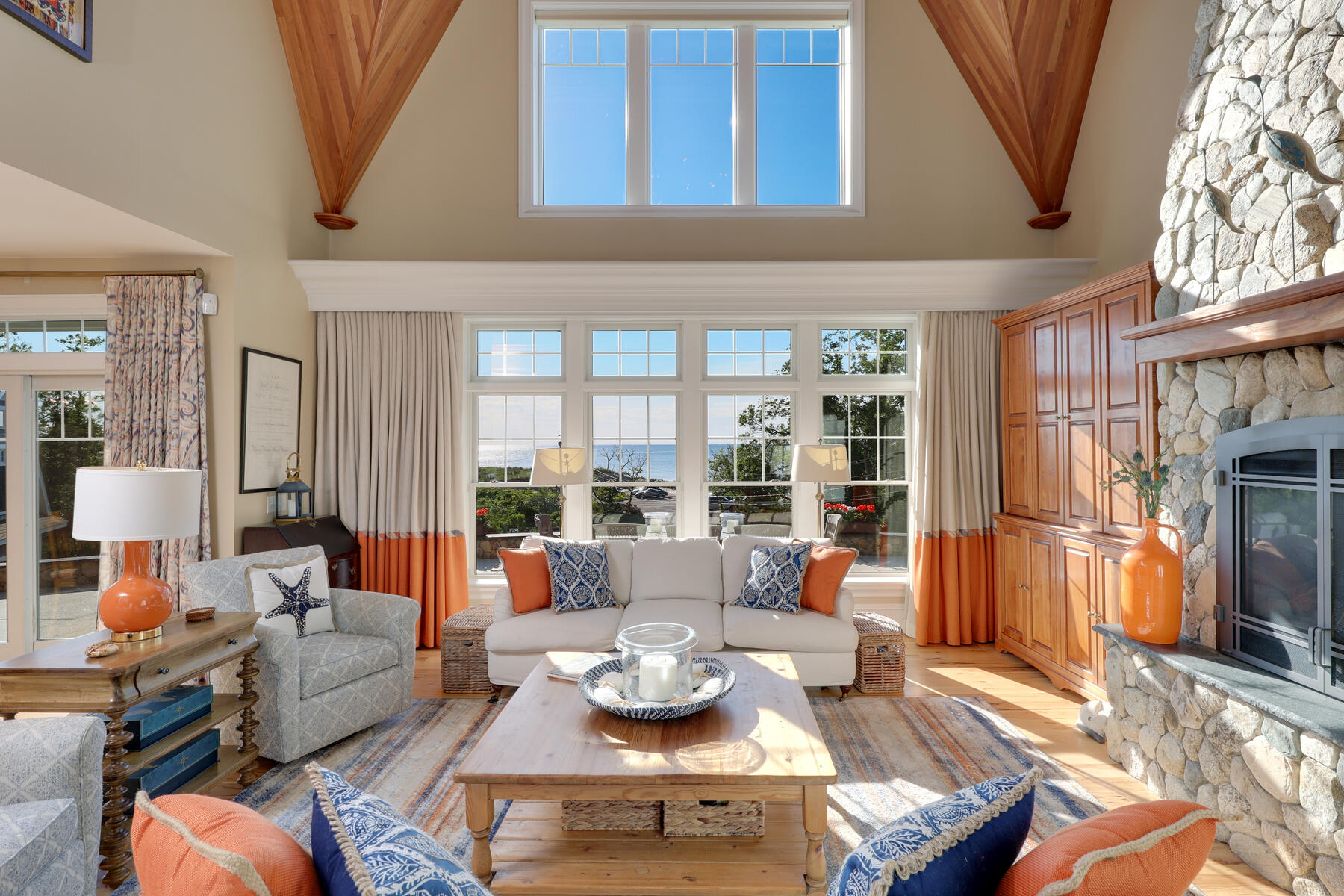 345 Robbins Hill Road Brewster, MA 02631 - Photo 33 of 95 a living room with furniture and a floor to ceiling window