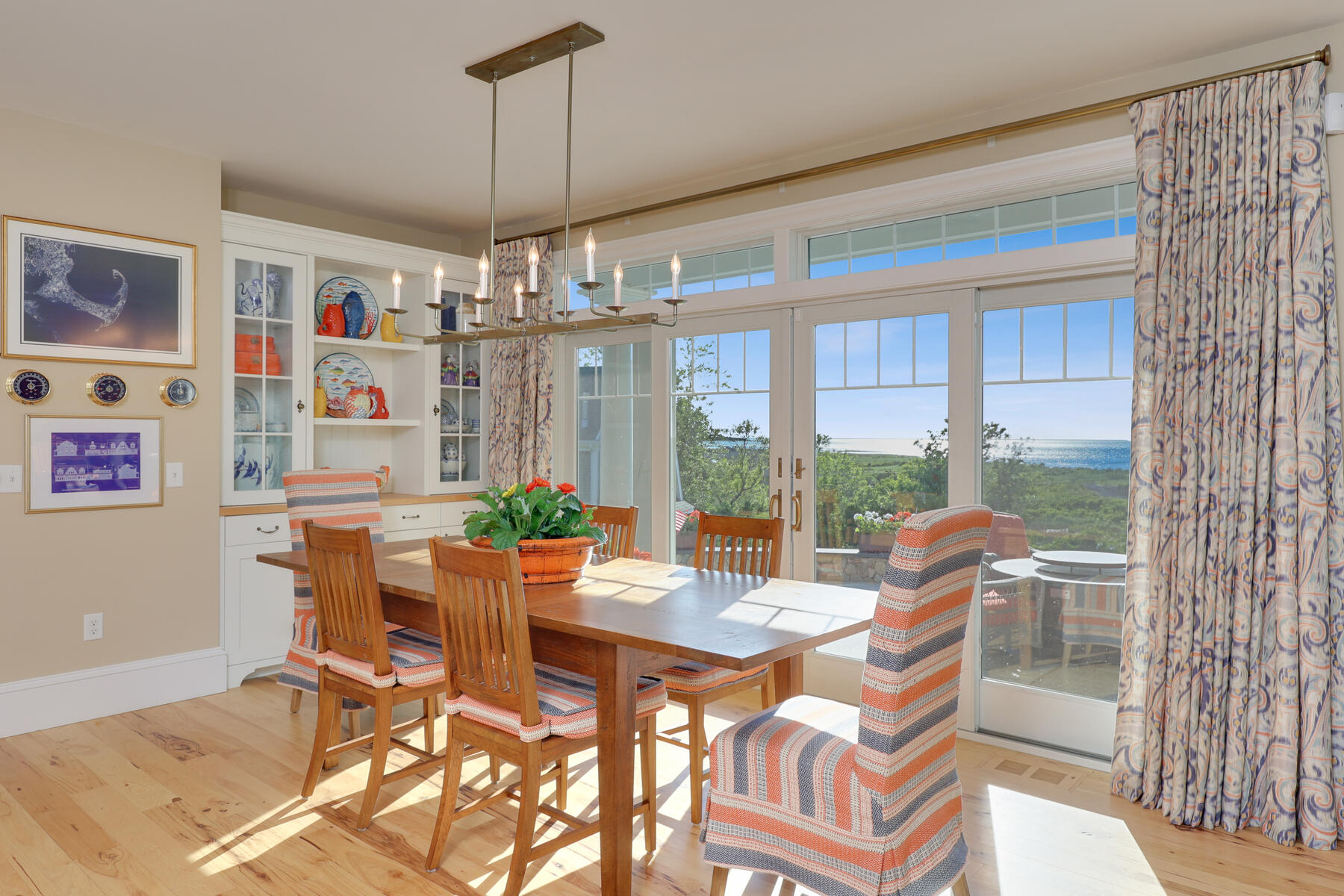 345 Robbins Hill Road Brewster, MA 02631 - Photo 40 of 95 a view of a dining room with furniture large windows and wooden floor